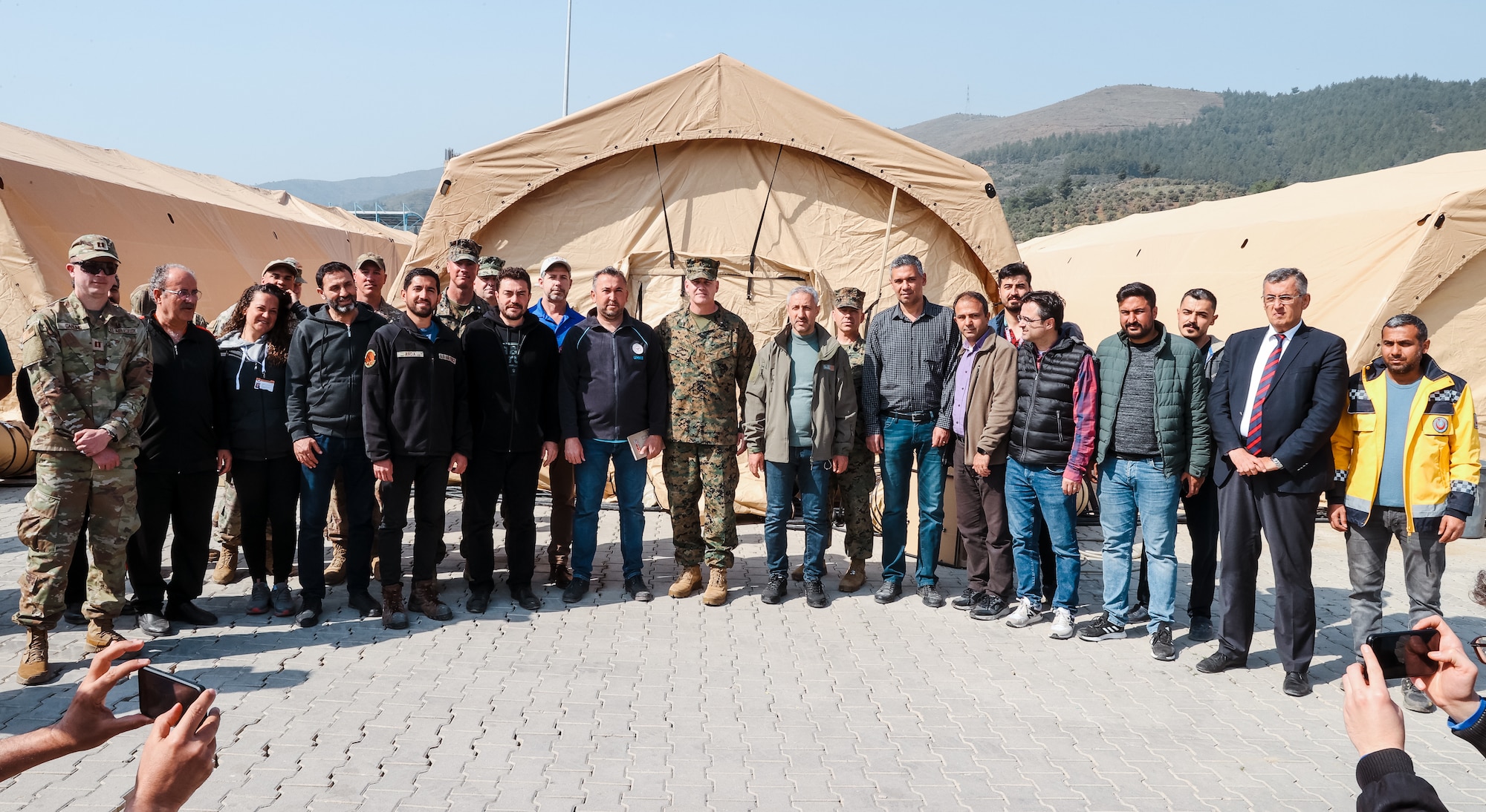 Brigadier Gen. Andrew T. Priddy, commanding general, Task Force 61/2, leadership from Task Force 61/2, and members of the Turkish Ministry of Health pose for a photo at Antakya, Türkiye, March 2, 2023. At the request of the Turkish government, U.S. military personnel assigned to Task Force 61/2 and 39th Air Base Wing were tasked with building a field hospital for the citizens who were affected by the Feb. 6 earthquakes. Upon completion of their efforts on March 2, 2023, leaders from Task Force 61/2 (TF 61/2), and 39th Air Base Wing conducted a final walk-through before the Turkish Ministry of Health began operations at the field hospital.