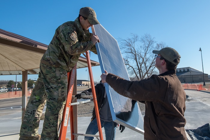 Staff Sgt. Daniel Doane, 22nd Civil Engineer Squadron power production craftsman, and Senior Airman Hunter Evans, 22nd Civil Engineer Squadron power production journeyman, install a solar panel on top of the gazebo in the Food Truck Park Feb. 2, 2023 at McConnell Air Force Base, Kansas. The 22nd CES has been working on a new Food Truck Park with plans to officially open in April. (U.S. Air Force photo by Airman 1st Class Felicia Przydzial)