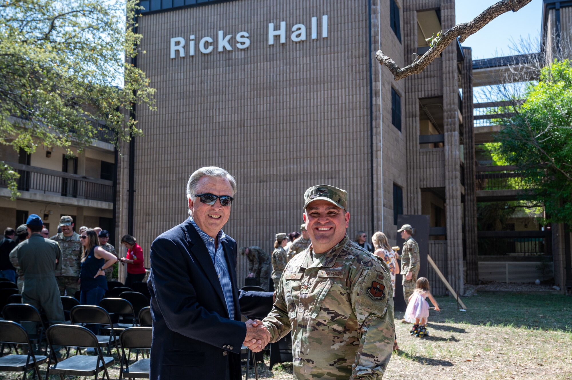 U.S. Air Force Col. Andrew Catz, 47th Flying Training Wing vice commander, and Lonnie Ricks pose for a photo in front of the Ricks Hall dormitory at Laughlin Air Force Base, Texas, on Mar. 6, 2023. The renovation project, which is set to begin in the coming months, will modernize and upgrade the living spaces for the enlisted men and women who call the dorms home. The renovations will include the addition of a kitchenette, new furniture, and appliances, as well as updates to the electrical and plumbing systems. (U.S. Air Force photo by Senior Airman David Phaff)