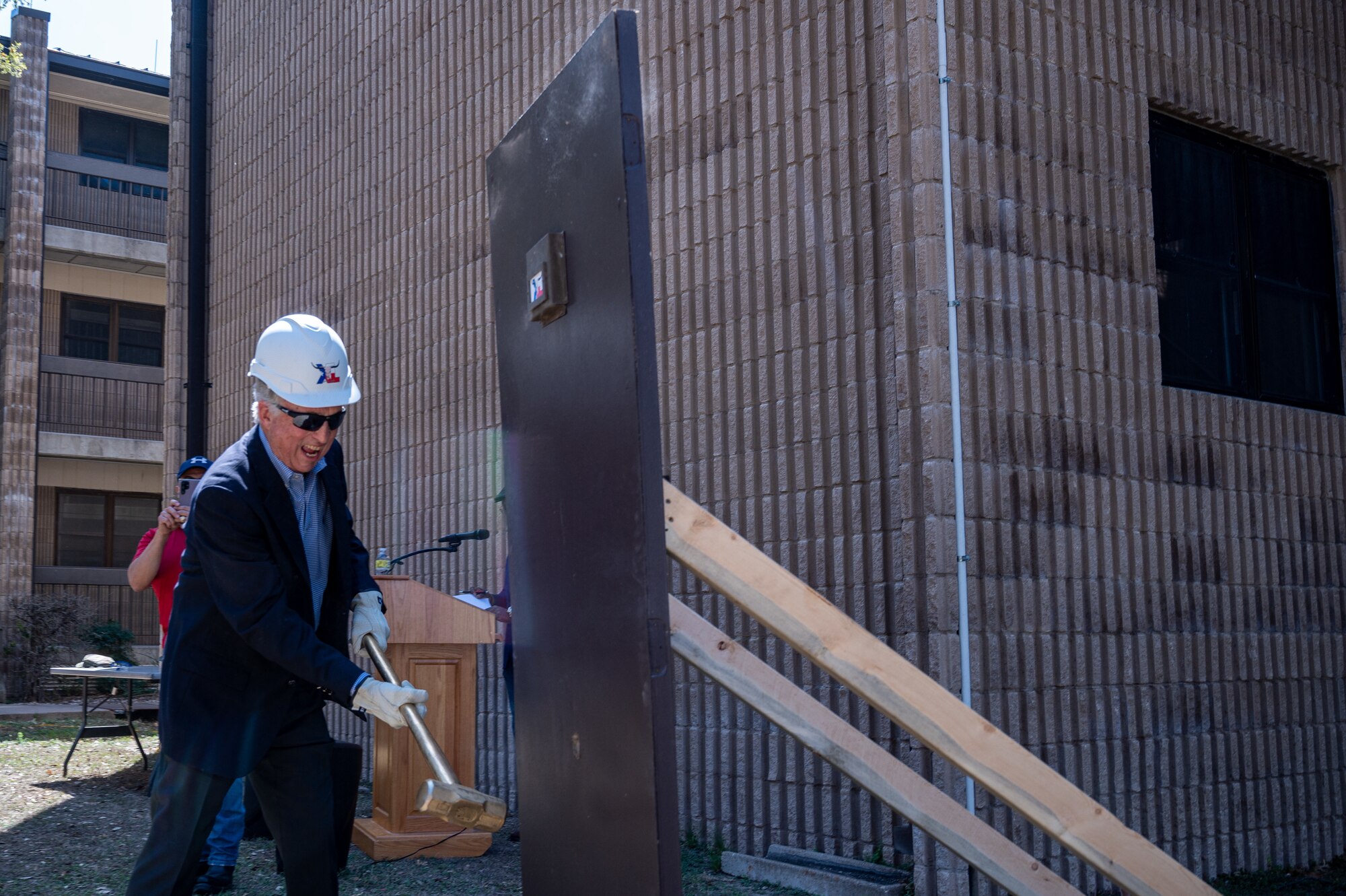 Lonnie Ricks swings a hammer to bring in the beginning of new construction at the Ricks Hall dormitory at Laughlin Air Force Base, Texas, on Mar. 6, 2023. The Air Force Civil Engineer Center funded this $35.3 million project. It will contribute to improving the base and give Airmen the ability to perform better by going home to a comfortable living space at the end of their day. (U.S. Air Force photo by Senior Airman David Phaff)