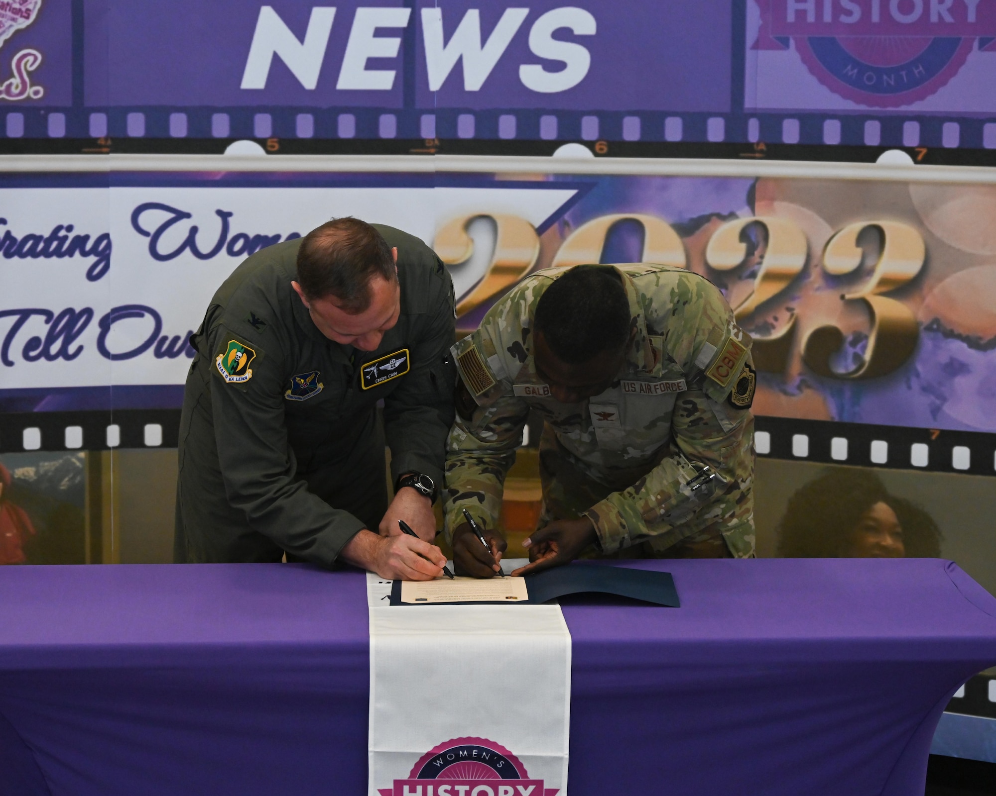 Col. Chris Cain, 5th Bomb Wing vice commander (left), and Col. Johnny Galbert, 91st Missile Wing vice commander, sign the 2023 Women’s History Month proclamation at Minot Air Force Base North Dakota, March 6, 2023. “Women are essential to Team Minot and the Air Force,” said Cain. “We are paying attention to these pathmakers, and are very excited to recognize the contributions and sacrifices they make every day.” (U.S. Air Force photo by Senior Airman Caleb S. Kimmell)