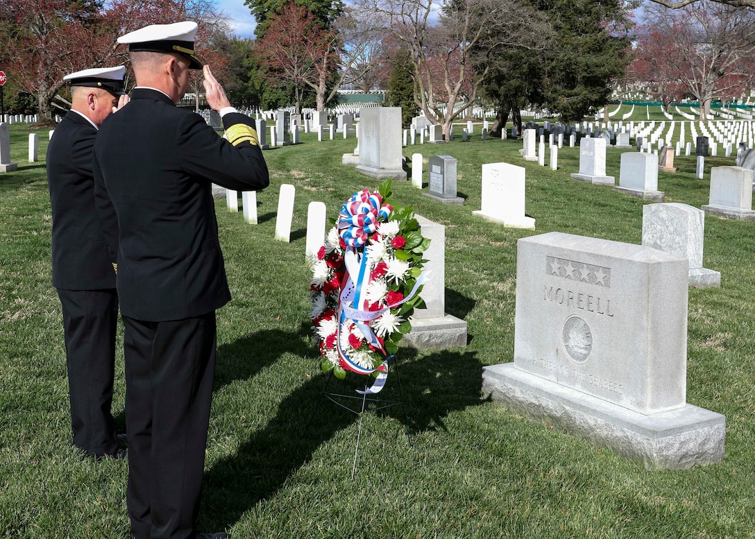 Rear Adm. Dean Vanderley and Force Master Chief Petty Officer of the Seabees Lawrence Sharpe salute during a Seabee birthday wreath-laying ceremony at the gravesite of Adm. Ben Moreell.