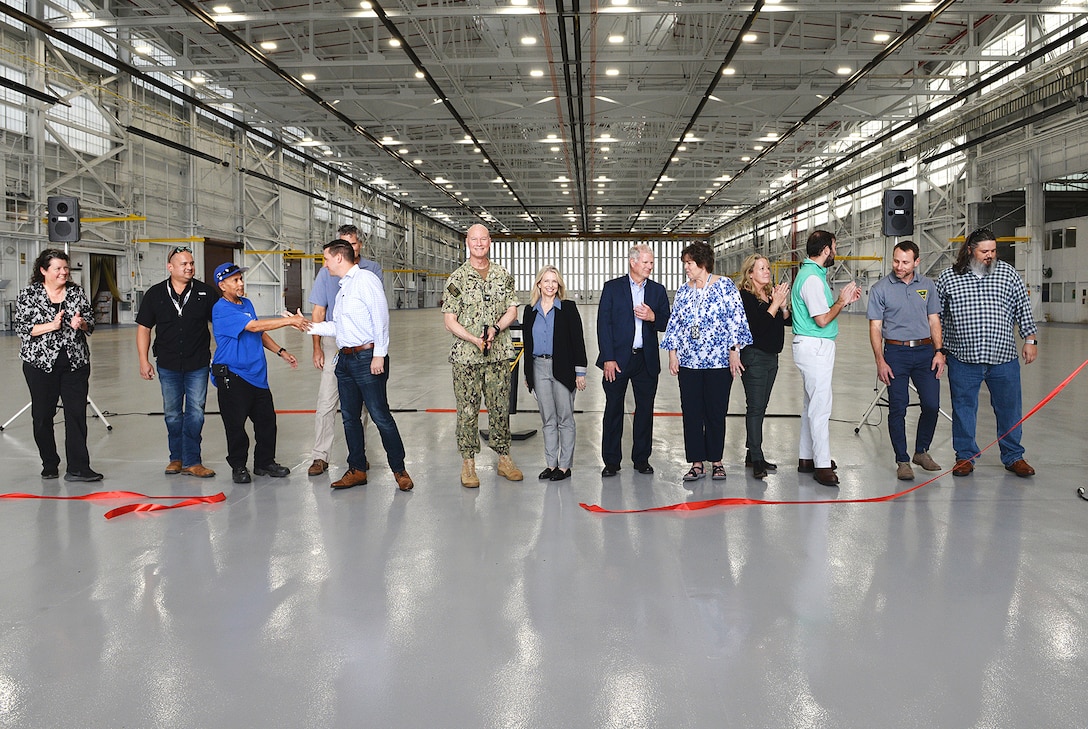 Officials from Fleet Readiness Center Southeast (FRCSE) and partner organizations cut the ribbon during a ribbon-cutting ceremony after the completion of the command's Hangar 101 Sustainment, Restoration and Modernization (SRM) project. (U.S. Navy Photo by Ashley Lombardo/Release)