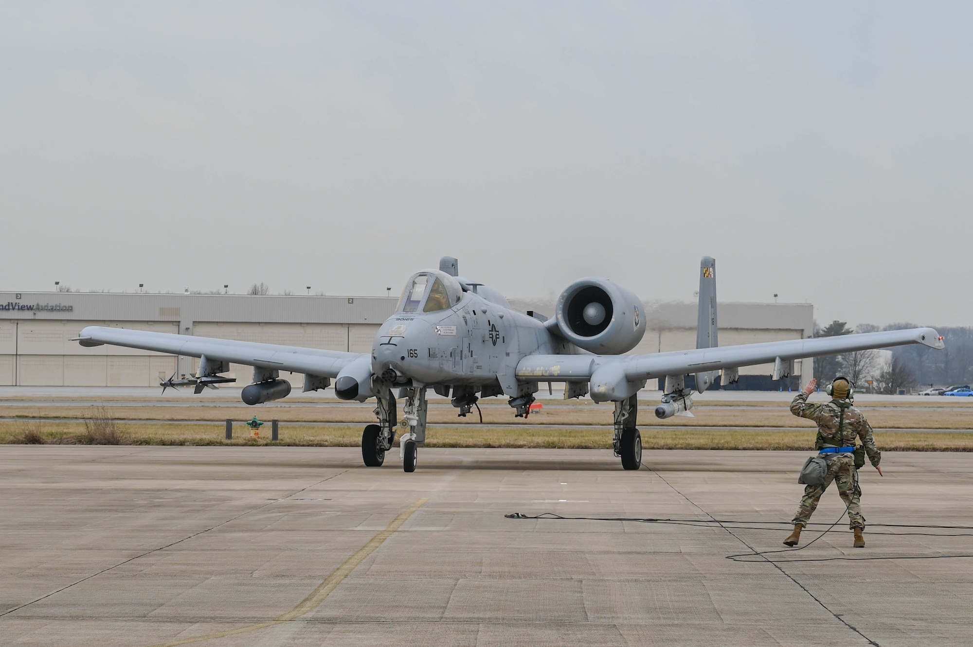 An Airman assigned to the 175th Aircraft Maintenance Squadron marshals in an A-10C Thunderbolt II during an integrated combat turn (ICT) March 2, 2023, as part of a readiness exercise at Martin State Air National Guard Base, Maryland.
