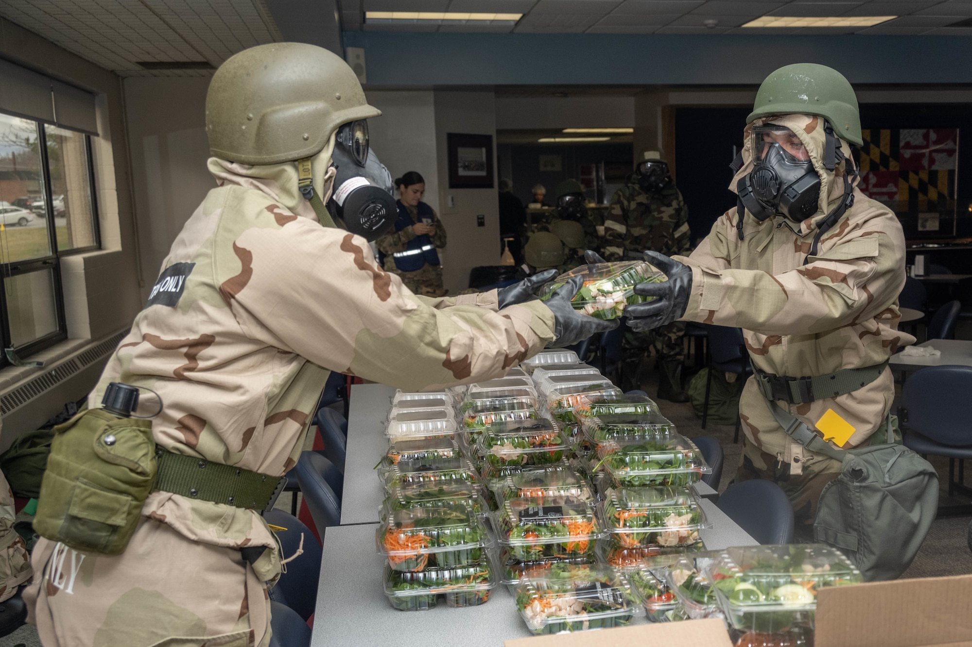 Services specialists with the 175th Force Support Squadron hand out meals during a readiness exercise March 4, 2023, at Martin State Air National Guard Base, Maryland.