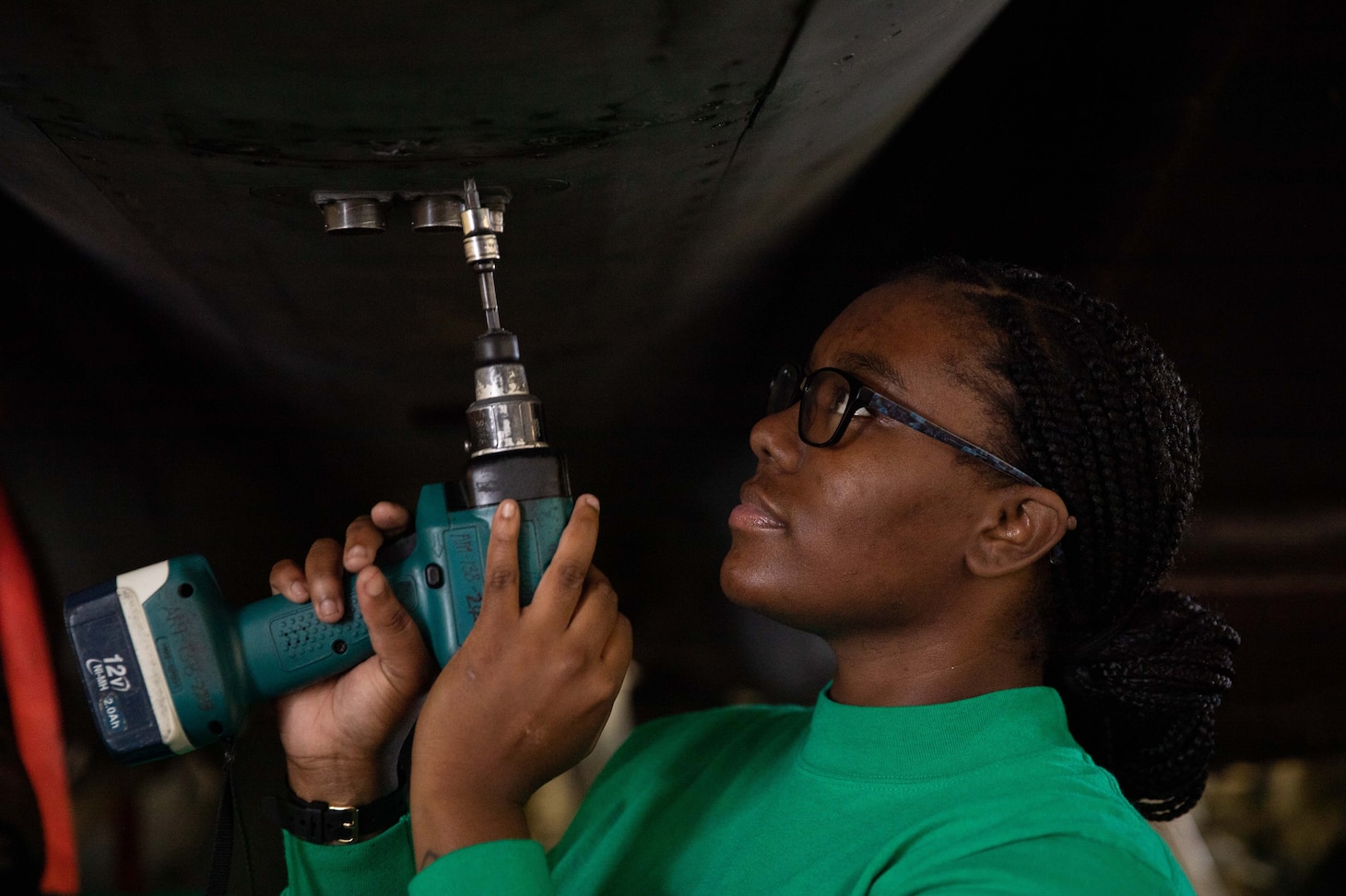 Aviation Structural Mechanic (Safety Equipment) 3rd Class Kaleigh Hudges, from Memphis, Tennessee, assigned to the "Tomcatters" of Strike Fighter Squadron (VFA) 31, screws in belly plates on an F/A-18E Super Hornet, in the first-in-class aircraft carrier USS Gerald R. Ford's (CVN 78) hangar bay, Oct. 13, 2022. The Gerald R. Ford Carrier Strike Group (GRFCSG) is deployed in the Atlantic Ocean, conducting training and operations alongside NATO Allies and partners to enhance integration for future operations and demonstrate the U.S. Navy’s commitment to a peaceful, stable and conflict-free Atlantic region.  (U.S. Navy photo by Mass Communication Specialist 2nd Class Jackson Adkins)