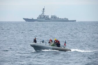 Sailors transfer parts from USS Thomas Hudner (DDG 116), back, to USS Normandy (CG-60) in the Atlantic Ocean.