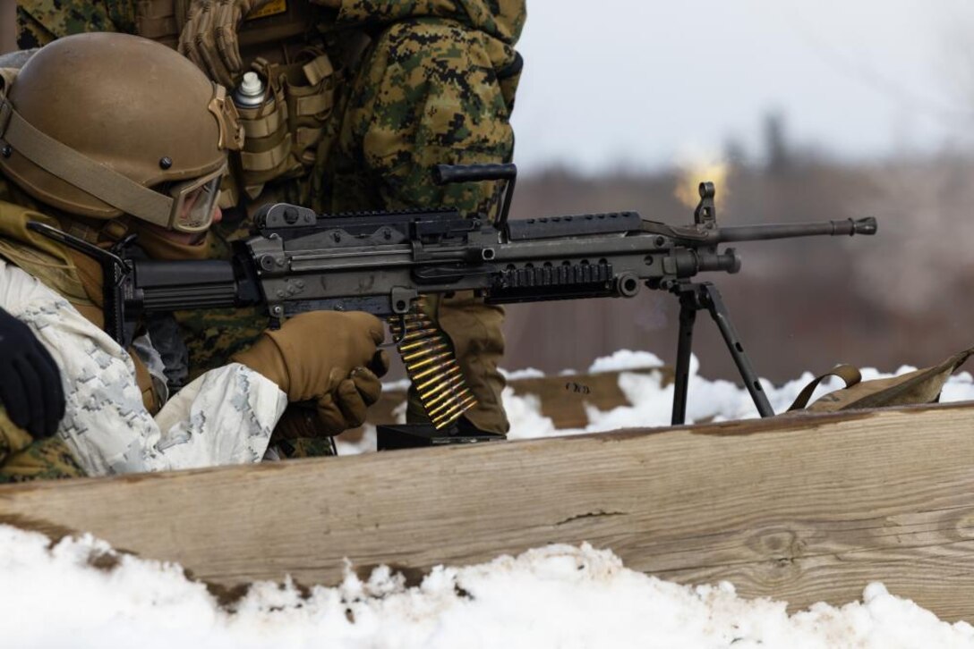 U.S. Marine Corps Lance Cpl. Julius Reyes, a network administrator, with 2nd Landing Support Battalion (LSB), Combat Logistics Regiment 27, 2nd Marine Logistics Group, fires a M249 light machine gun during a machine gun range on Fort Drum, New York, Feb. 26, 2023. Marines with 2nd LSB utilize the M240B machine gun and the M249 light machine gun during cold weather training to sustain and enhance their support capabilities in an austere environment. (U.S. Marine Corps photo by Lance Cpl. Mary Kohlmann)