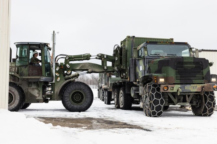 U.S. Marine Corps Lance Cpl. Trenton Tackett, an engineer equipment operator with 2nd Landing Support Battalion (LSB), Combat Logistics Regiment 27, 2nd Marine Logistics Group, moves cargo off of a Medium Tactical Vehicle Replacement on Fort Drum, New York, March 2, 2023. Marines with 2nd LSB transported gear to set up the command operations center, barracks, medical facility, and a chow hall to sustain and enhance their support capabilities in an austere environment. (U.S. Marine Corps photo by Lance Cpl. Mary Kohlmann)