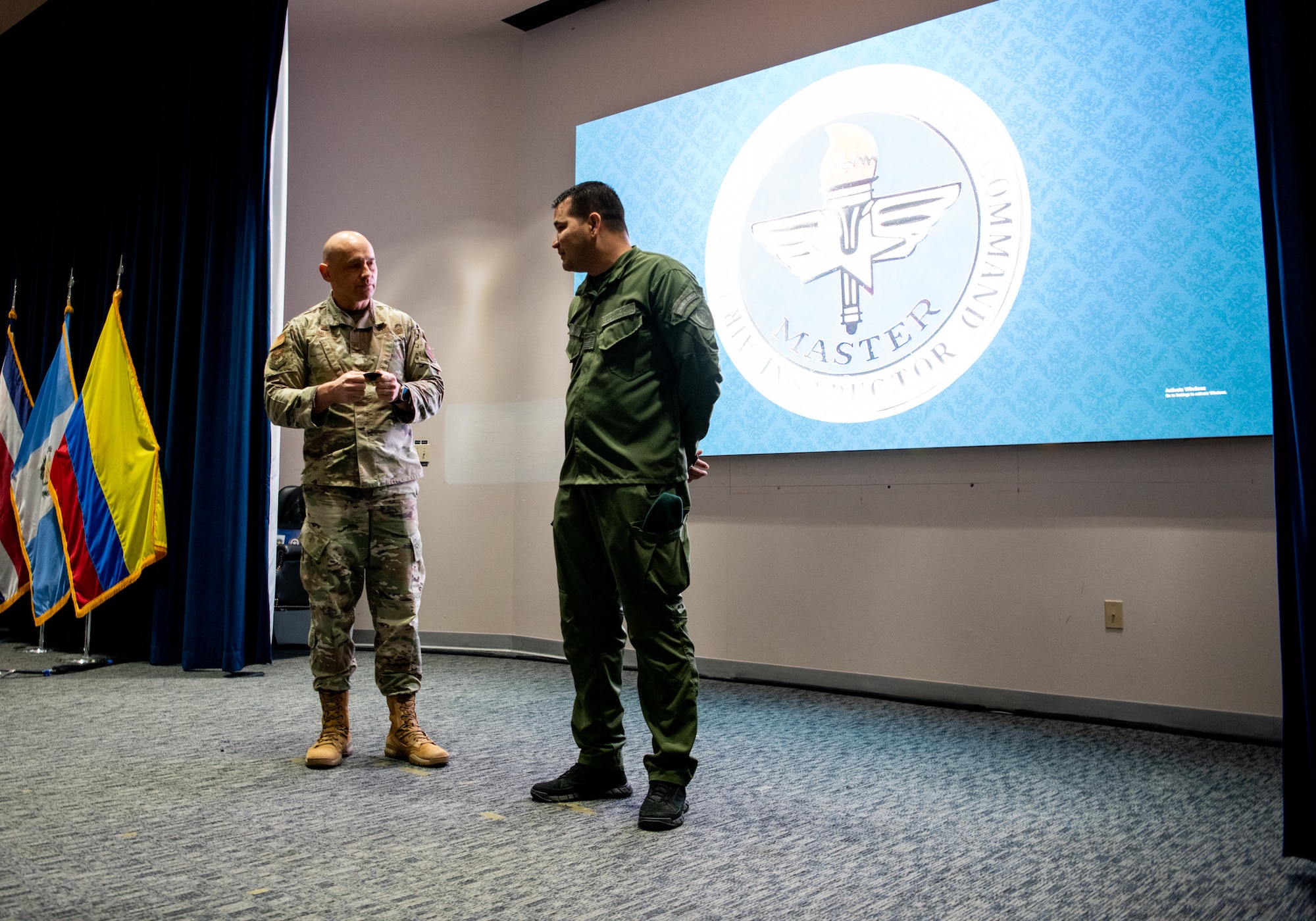 Col. José Jimenez, Jr., Commandant of the Inter-American Air Forces Academy, holds speaks to Intendente Jefe Alexander Pacheco of Colombia’s National Police, at JBSA-Lackland, Texas, Feb. 17, 2023. Pacheco, a partner nation guest instructor at IAAFA, recently earned the Air Education Training Command Master Instructor designation. He is the first international member to earn master instructor, which is the highest honor one can earn as an instructor. (U.S. Air Force photo by Vanessa R. Adame)