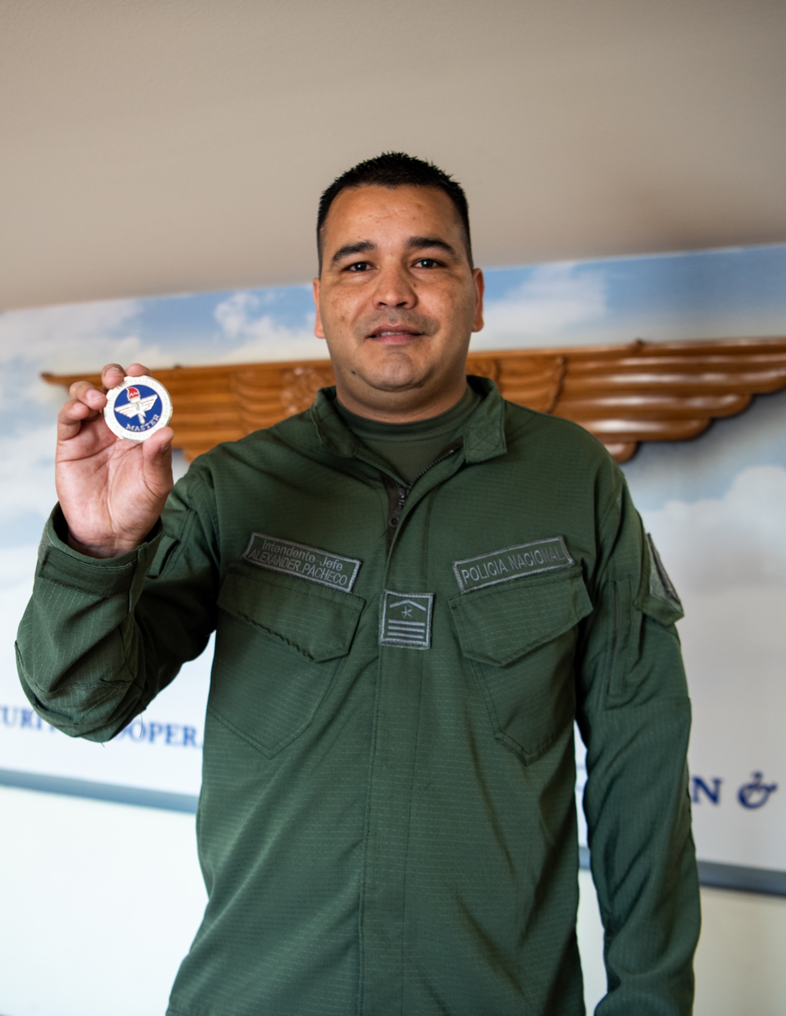 Intendente Jefe Alexander Pacheco of Colombia’s National Police, holds a coin at the Inter-American Air Forces Academy, Feb. 17, 2023. Pacheco, a partner nation guest instructor at IAAFA, recently earned the Air Education Training Command Master Instructor designation. He is the first international member to earn master instructor, which is the highest honor one can earn as an instructor. (U.S. Air Force photo by Vanessa R. Adame)