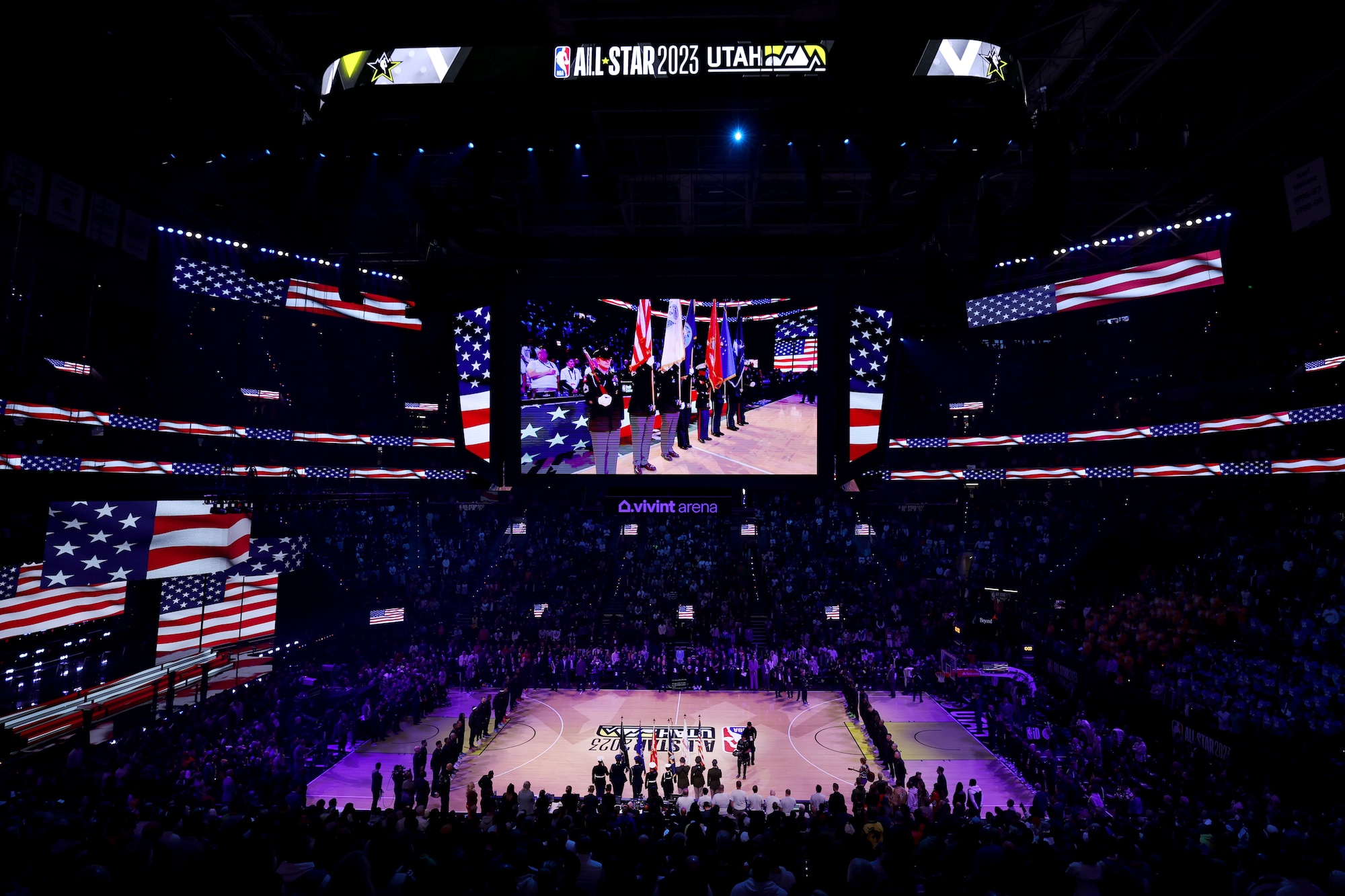 A joint service color guard including Senior Airman Tyrone Treadwell, holding the Air Force flag, and Senior Airman Mason Gonzales, holding the Space Force flag, during the national anthem ahead of the NBA All-Star Game