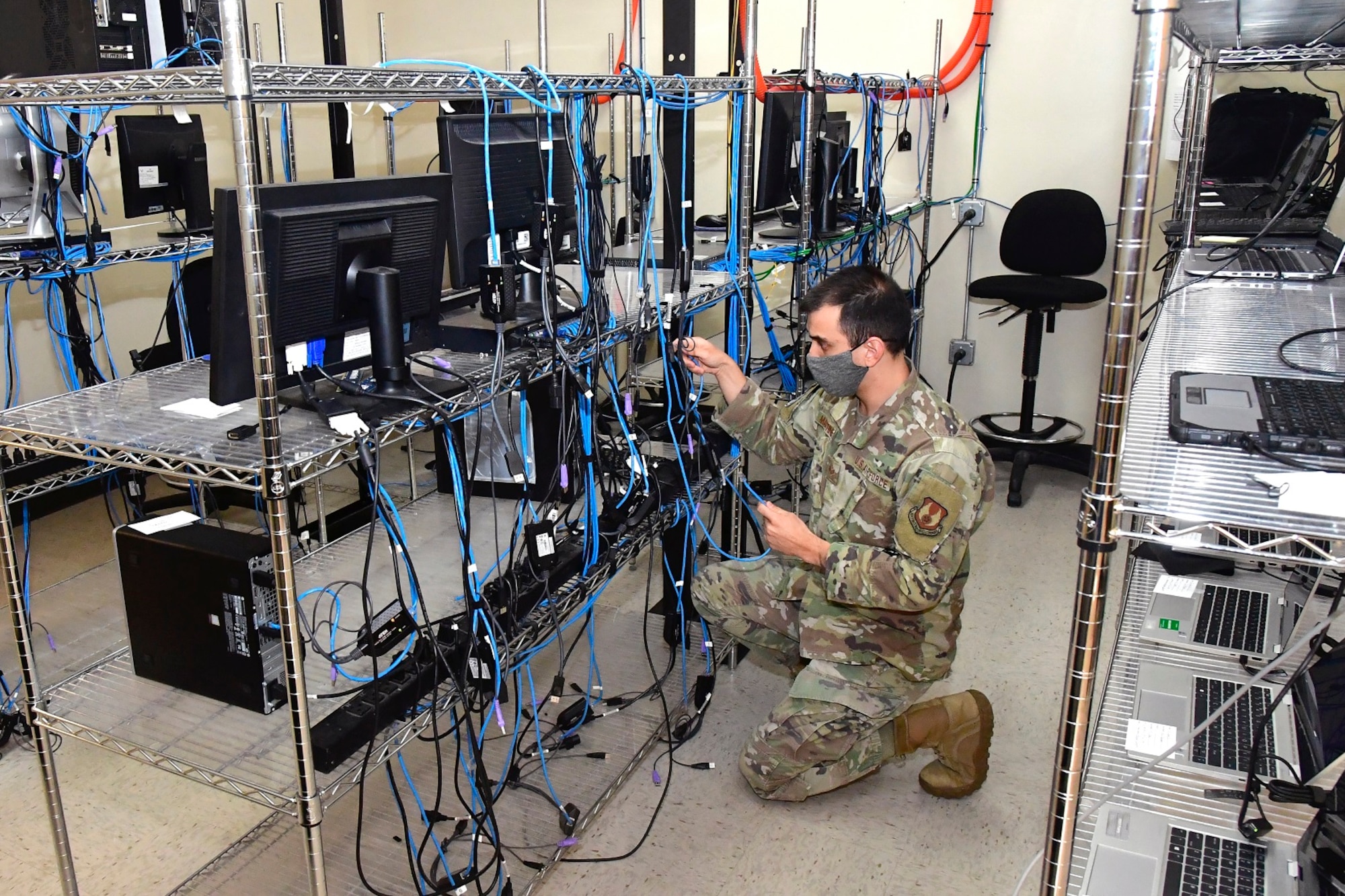 Senior Airman Mario Martinez, client systems technician, checks feed cable connections in 2021. The 75th Communications and Information Directorate at Hill notched an excellent score on its February 2023 Command Cyber Readiness Inspection. (U.S. Air Force photo by Todd Cromar)