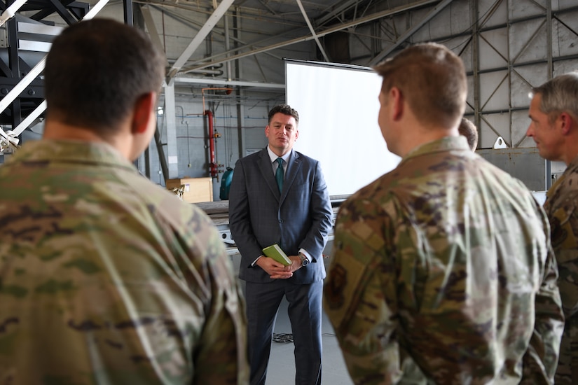 A man speaks to members of the military.