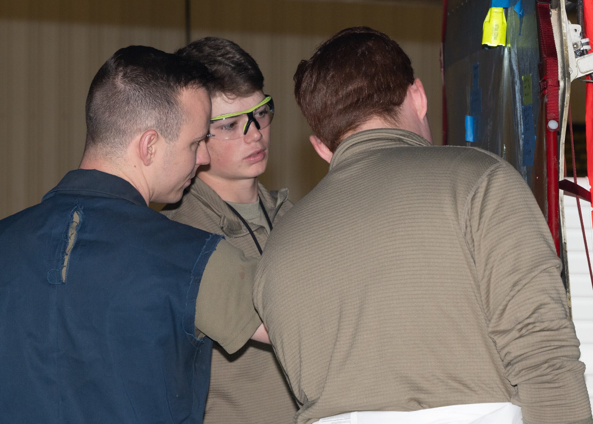 Staff Sgt. Tyler Beverlin, 131st Maintenance Squadron low observable technician, shows Airman 1st Class Whitford Sullivan and Airman Micah Carben of the 509th Maintenance Group what the discrepant material is at Whiteman Air Force Base, Mo., Feb. 22, 2023. Beverlin reviewed work of Airmen who are working on their certification so they can become task certified. (U.S. Air Force photo by Senior Airman Nash Truitt)