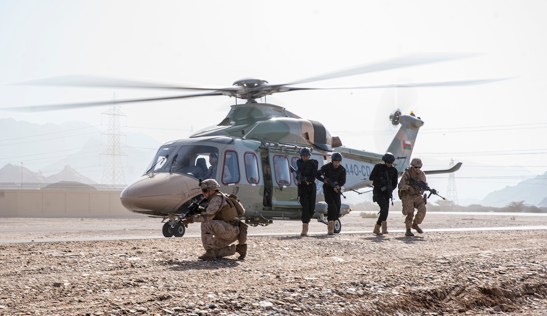 U.S. Marines assigned to Fleet Anti-Terrorism Security Team Central Command and members of the Royal Oman Police Special Task unit run from a Eurocopter EC225LP Super Puma after loading a simulated casualty during the final demonstration in exercise Invincible Sentry 23 in Oman, Feb. 23, 2023. IS23 is a recurring exercise held with different partner nations each year within U.S. Central Command’s area of responsibility to evaluate the readiness and capabilities of U.S. and Omani forces responding to a regional emergency.