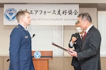 Maj. Lance Mazzella, 374th Logistics Readiness Squadron director of operations, accepts the Japan-America Air Force Goodwill Association Award from Yoshiyuki Sugiyama, JAAGA president, during a ceremony at Yokota Air Base, Japan, March 3, 2023. JAAGA promotes friendship and mutual understanding between JASDF and U.S. Air Force members by annually honoring distinguished performers from both nations. Recipients are members who have exceptionally contributed to the mutual understanding and friendship between U.S. Forces in Japan and the JASDF.