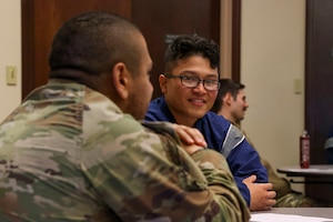 U.S. Air Force Senior Airman Kwon Arteage, 9th Civil Engineer Squadron water and fuels system maintenance technician, speaks with another Airman during the Beale Social on Feb. 27, 2023, at Beale Air Force Base, Calif.