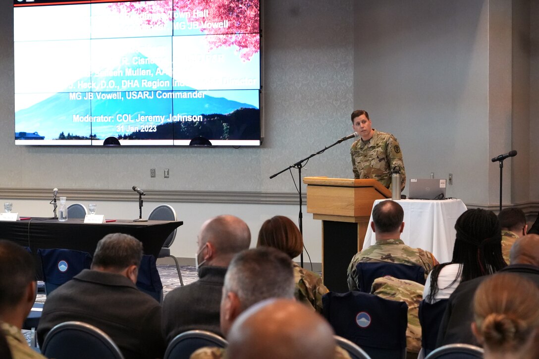 U.S. Army Medical Command – Japan commander, Col. Jeremy Johnson, briefs to a ‘space available’ town hall at the Camp Zama Community Club, January 31, 2023. The town hall was held in response to Department of Defense civilians being restricted to ‘space available’ clinic visits after a mandate released in 2017 prioritized active-duty Servicemembers and their families, or those who were covered by the military health plan TRICARE Prime. Guest speakers, to include the Under Secretary of Defense for Personnel and Readiness, Hon. Gilbert R. Cisneros, Acting Assistant Secretary of DHA, Ms. Seileen Mullen, and U.S. Army Maj. Gen. Joseph Heck, the director of Department for Health Affairs Region Indo-Pacific to Japan, along with U.S. Army Japan Commanding General, Maj. Gen. JB Vowell, were in attendance to listen to concerns from DoD civilians and offer pending solutions to the difficulty of receiving health care from off-installation providers in Japan.