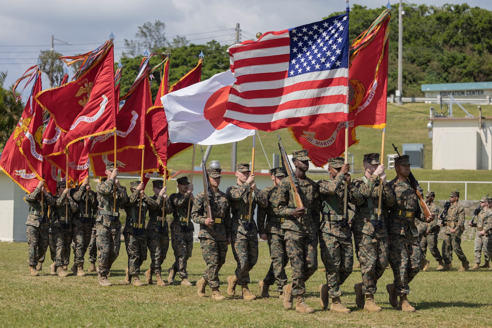 U.S. Marines conduct a pass and review during a relief and appointment ceremony on Marine Corps Base Camp Butler, March 7, 2023. Sgt. Maj. Eric D. Cook relinquished his duties as sergeant major of III Marine Expeditionary Force, and sergeant major of Marine Forces Japan to Sgt. Maj. Joy M. Kitashima. (U.S. Marine Corps photo by Cpl. Diana Jimenez)