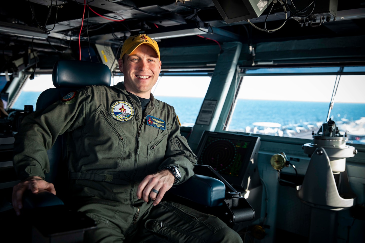 Lt. Cmdr. Andrew Whelan, assistant navigation officer aboard the Nimitz-class aircraft carrier USS George H.W. Bush (CVN 77), poses for a photo on the navigation bridge, March 6, 2023. The George H.W. Bush Carrier Strike Group is on a scheduled deployment in the U.S. Naval Forces Europe area of operations, employed by U.S. Sixth Fleet to defend U.S., allied and partner interests.