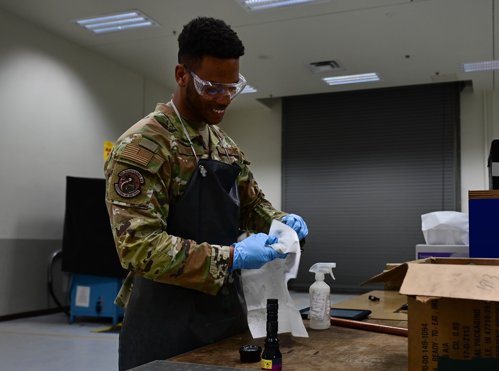 Airman 1st Class Jaylin Tripp, 8th Maintenance Squadron nondestructive inspection specialist, cleans a piece of aircraft equipment after testing at Kunsan Air Base, Republic of Korea, Mar. 6, 2023.