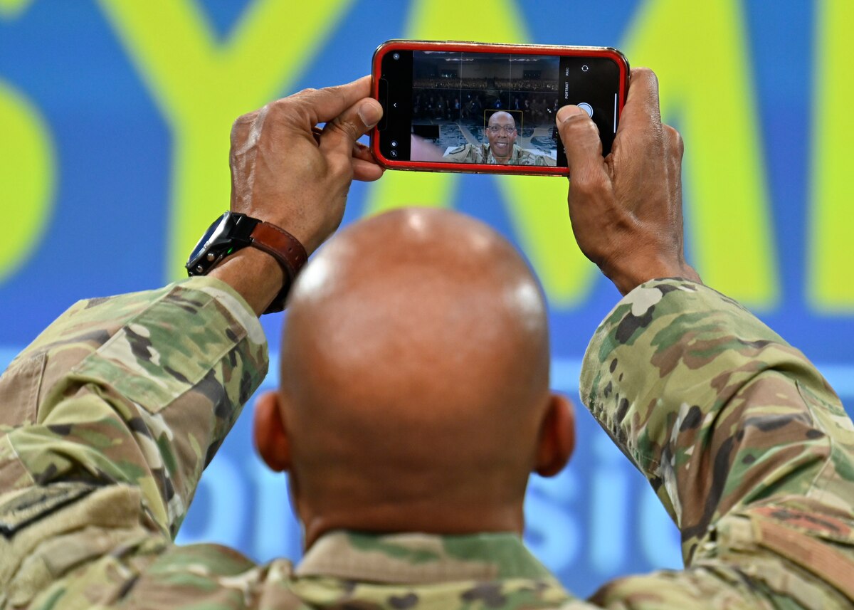 Air Force Chief of Staff Gen. CQ Brown, Jr. takes a selfie with the audience during his keynote speech “Airmen in the Fight” at the Air and Space Forces Association 2023 Warfare Symposium in Aurora, Colo., March 7, 2023. (U.S. Air Force photo by Eric Dietrich)
