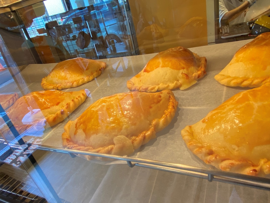 Golden brown empanadas on display at Rock-N-Roll burrito, a family-owned Mexican cantina-style establishment located near Naval Air Facility Atsugi. ‘Hecho Con Mucho Amor,’ or ‘Made with immense love’ in Spanish, is painted above the entranceway to the kitchen, and embodies the mission of owner Hajime Higa, a Peru native and long-time Japanese resident, whose goal is to provide freshly made Mexican cuisine for U.S. servicemembers and their families with as much love and care as possible.