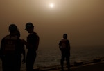 03/27/03, North Persian Gulf - Coast Guardsmen aboard the U.S. Coast Guard Boutwell chat on the flight deck following refueling operations at sunset.
The Boutwell, homeported in Alameda, California., is in the Gulf in support of Operation Iraqi Freedom.