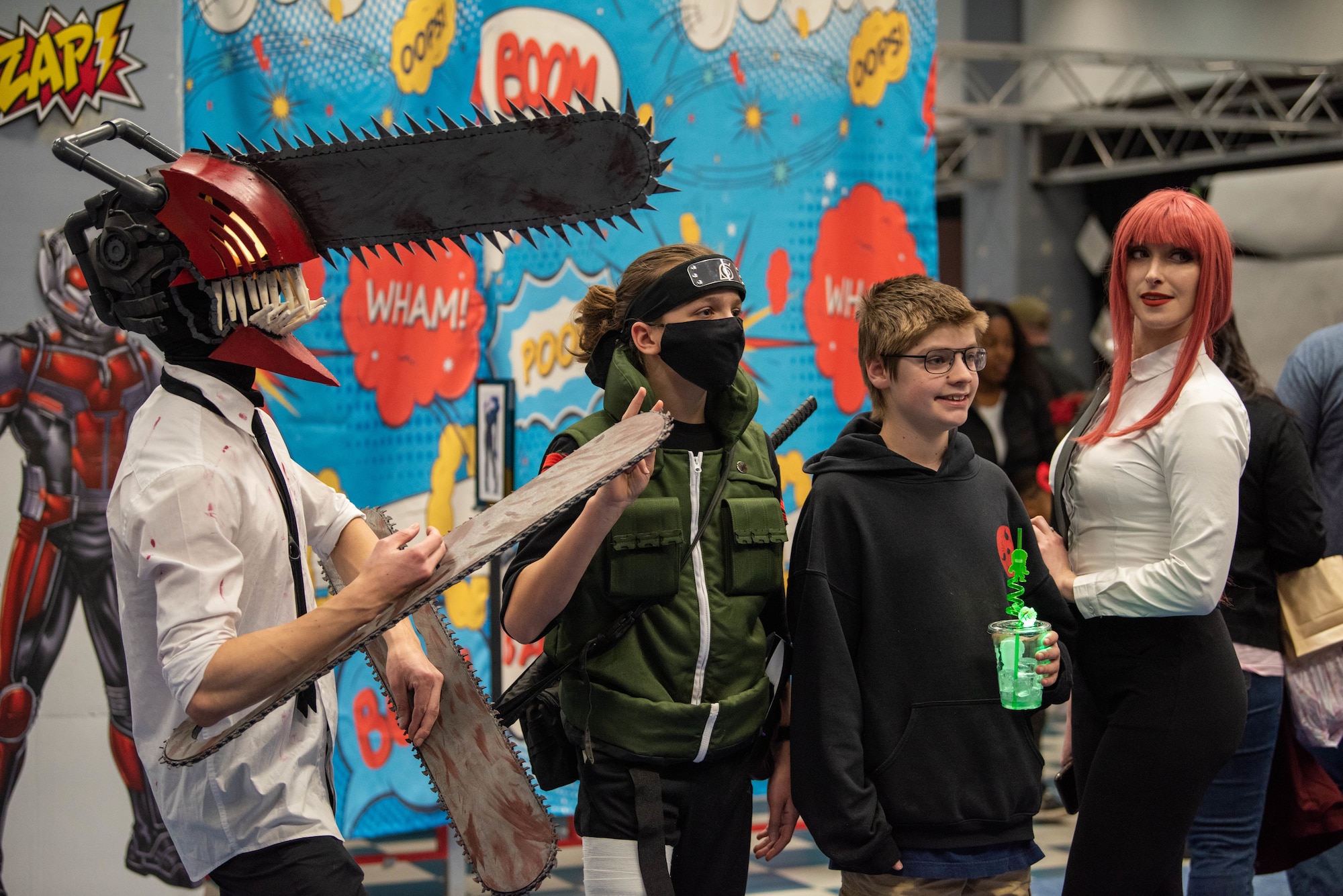 People dressed in costumes pose for a photo.