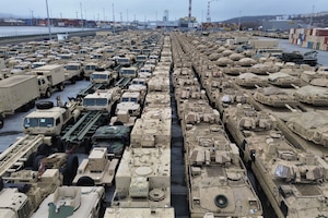 Military equipment sits on a loading dock.