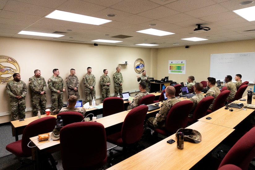 Army Chief Warrant Officer 4 Jennifer Ritchie (center) introduces new graduates of Warrant Officer Candidacy School to warrant officer applicants at Boone National Guard Center in Frankfort, Ky. on Oct. 15, 2022. The newly commissioned warrant officers are presenting mentor hour to Soldiers in the Warrant Officer Candidate Accession Program with the Kentucky National Guard. (U.S. Army photo by Andy Dickson)