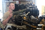 Cpl. Wyatt Chapman of India Company, 328th Brigade Support Battalion, 56th Stryker Brigade Combat Team, performs maintenance on a Stryker vehicle engine at the California National Guard Maneuver Area Training Equipment Site during the 56 SBCT’s rotation at the National Training Center, Fort Irwin, Calif., June 22, 2022.