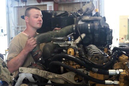 Cpl. Wyatt Chapman of India Company, 328th Brigade Support Battalion, 56th Stryker Brigade Combat Team, performs maintenance on a Stryker vehicle engine at the California National Guard Maneuver Area Training Equipment Site during the 56 SBCT’s rotation at the National Training Center, Fort Irwin, Calif., June 22, 2022.