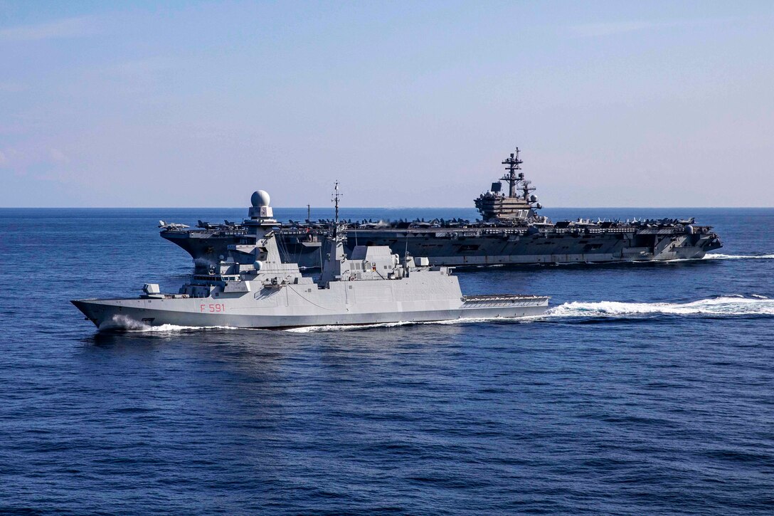 Two ships side by side sail in the Mediterranean Sea