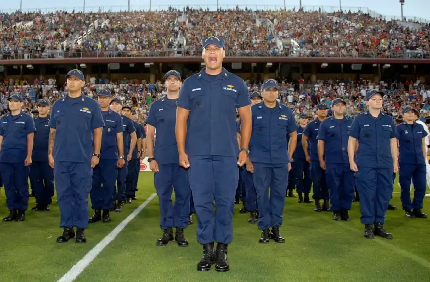 Coast Guard members assigned to Coast Guard Island in Alameda, Calif., stand at attention during a Galaxy soccer game at Stanford Stadium in Calif., Saturday, June 29, 2013. During the halftime show, fans and players paused to recognize approximately 500 military members from different branches. (U.S. Coast Guard photo by Petty Officer 3rd Class Loumania Stewart)