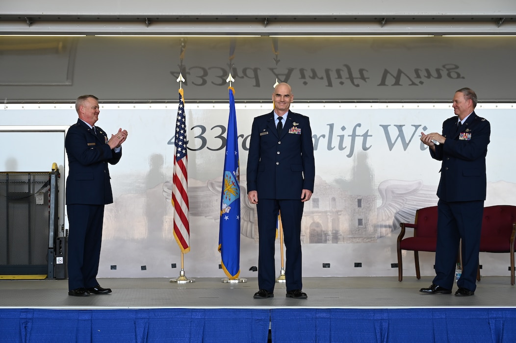 Brig. Gen. Derin Durham, 4th Air Force commander, left, and Col. Terry McClain, former 433rd Airlift Wing commander, right, applaud Col. William Gutermuth, 433rd AW commander, center, during a change of command ceremony March, 5, 2023, at Joint Base San Antonio-Lackland, Texas. Gutermuth was formerly the commander of the 514th Air Mobility Wing located at Joint Base McGuire-Dix-Lakehurst, New Jersey. (U.S. Air Force photo by Master Sgt. Samantha Mathison)