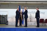 Brig. Gen. Derin Durham, 4th Air Force commander, offers the 433rd Airlift Wing guidon to Col. William Gutermuth, 433rd AW commander, during a change of command ceremony March, 5, 2023, at Joint Base San Antonio-Lackland, Texas. Gutermuth was formerly the commander of the 514th Air Mobility Wing located at Joint Base McGuire-Dix-Lakehurst, New Jersey. (U.S. Air Force photo by Master Sgt. Samantha Mathison)