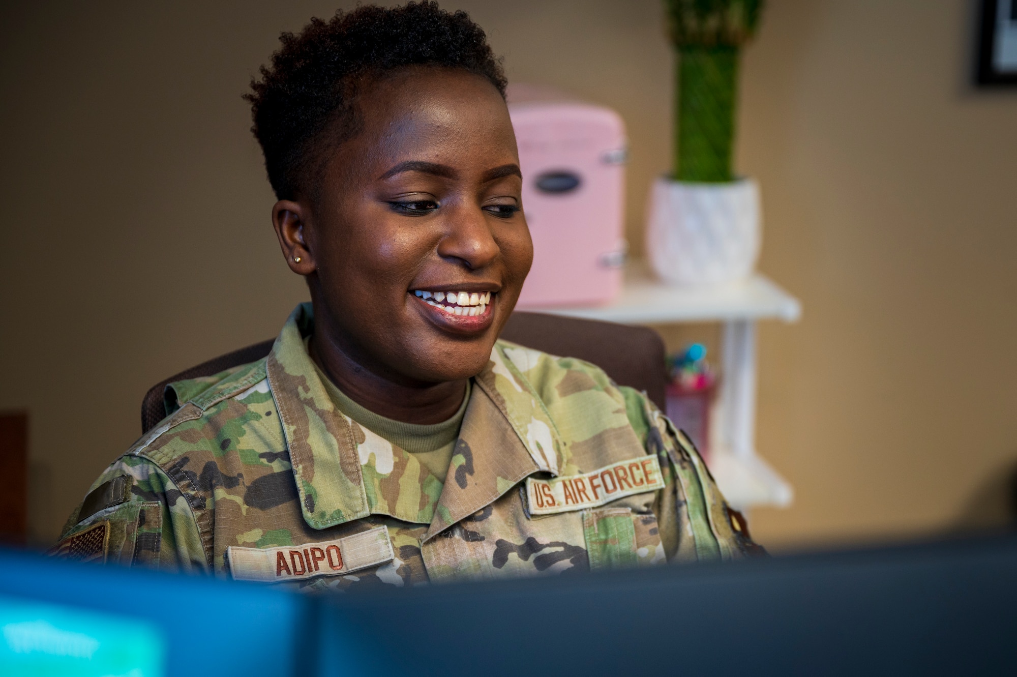 U.S. Air Force Staff Sgt. Winnie Adipo, 56th Medical Group noncommissioned officer in charge of personnel administration, processes documents in her office, at Luke Air Force Base, Jan. 17, 2023.