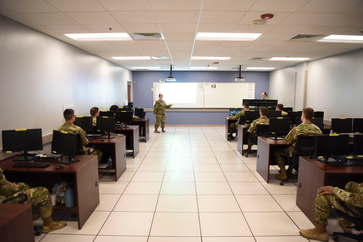 U.S. Air Force Tech. Sgt. Jan Neverdosky, 316th Training Squadron instructor, teaches students during the Analysis and Production Course.