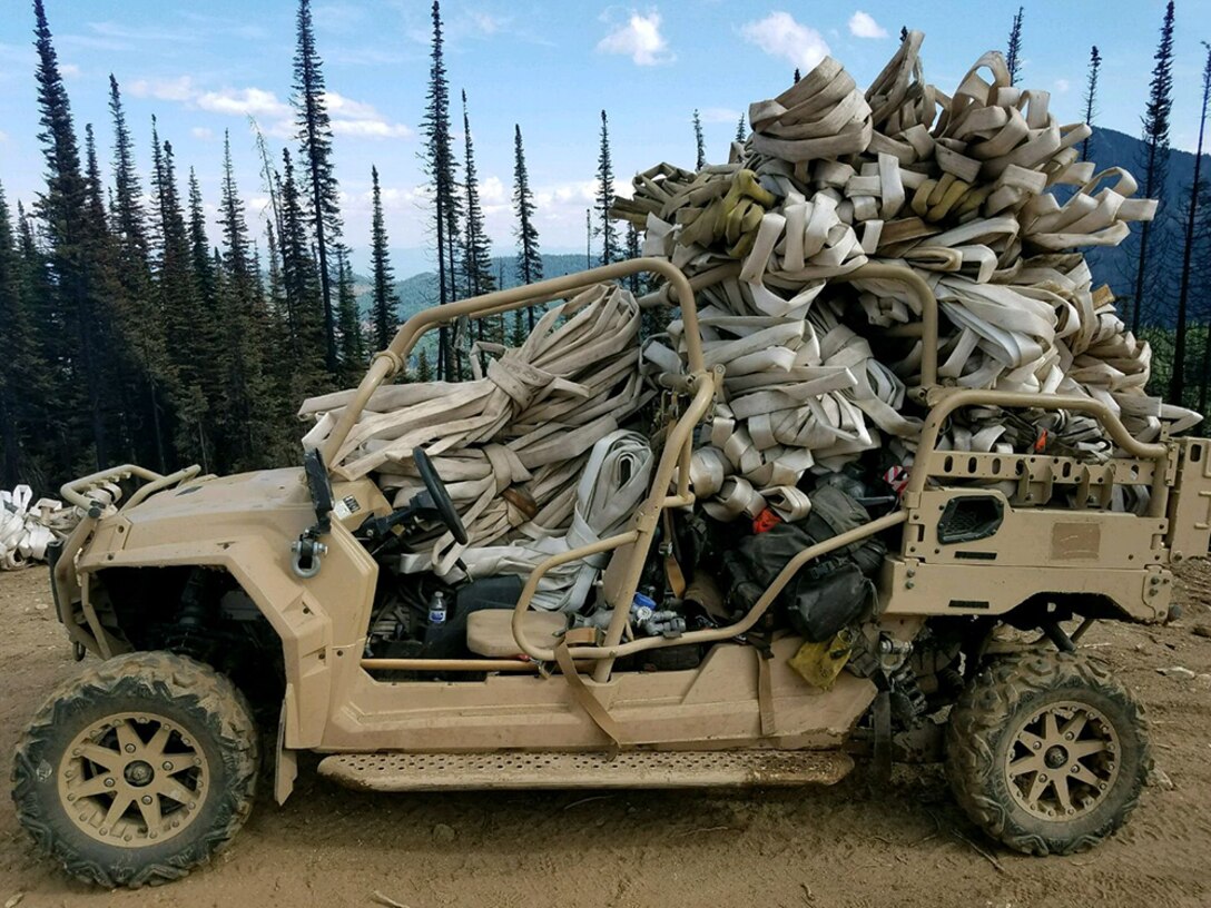 An off-road vehicle loaded down with hoses.