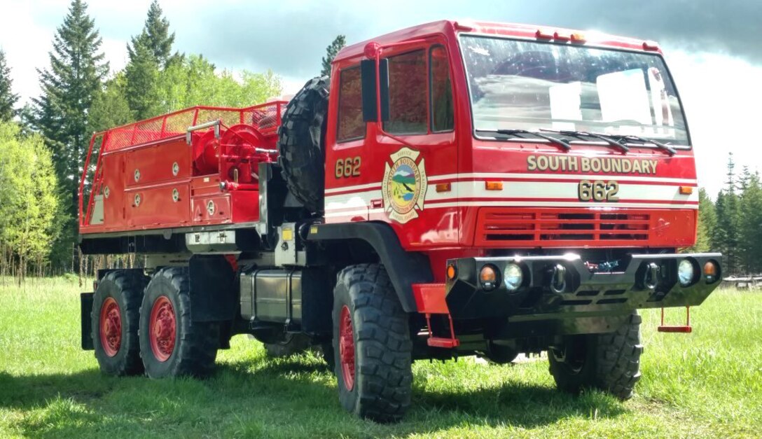 A firetruck in a field.