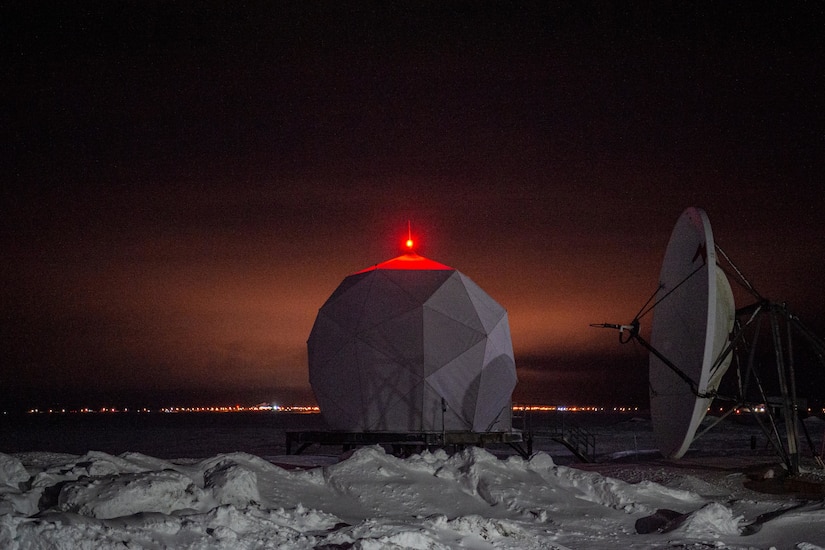A radar site is shown at night.