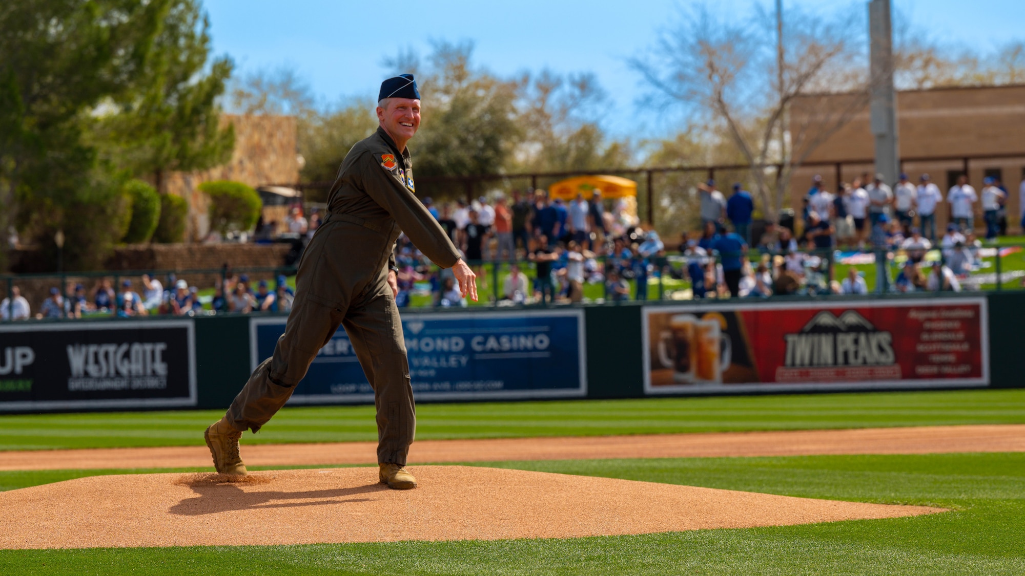 U.S. Air Force Brig. Gen. Jason Rueschhoff, 56th Fighter Wing commander, throws the ceremonial first pitch, March 5, 2023, at Camelback Ranch in Glendale, Arizona.