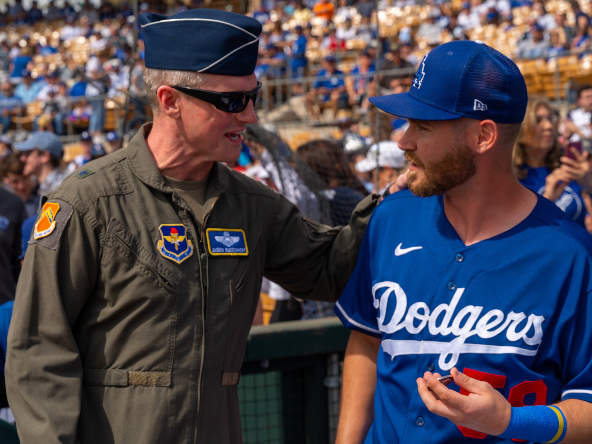 U.S. Air Force Brig. Gen. Jason Rueschhoff, 56th Fighter Wing commander, presents Patrick Mazeika, Los Angeles Dodgers catcher, with a coin March 5, 2023, at Camelback Ranch, Glendale, Arizona.