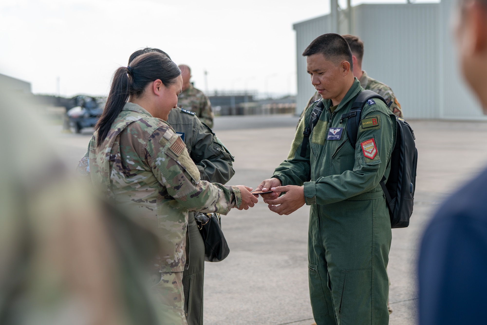 A Philippine Air Force member and an Airman trade patches.