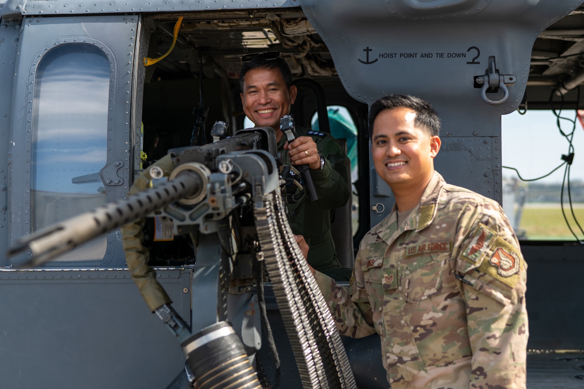 A Philippine Air Force member and an Airman pose for a photo.