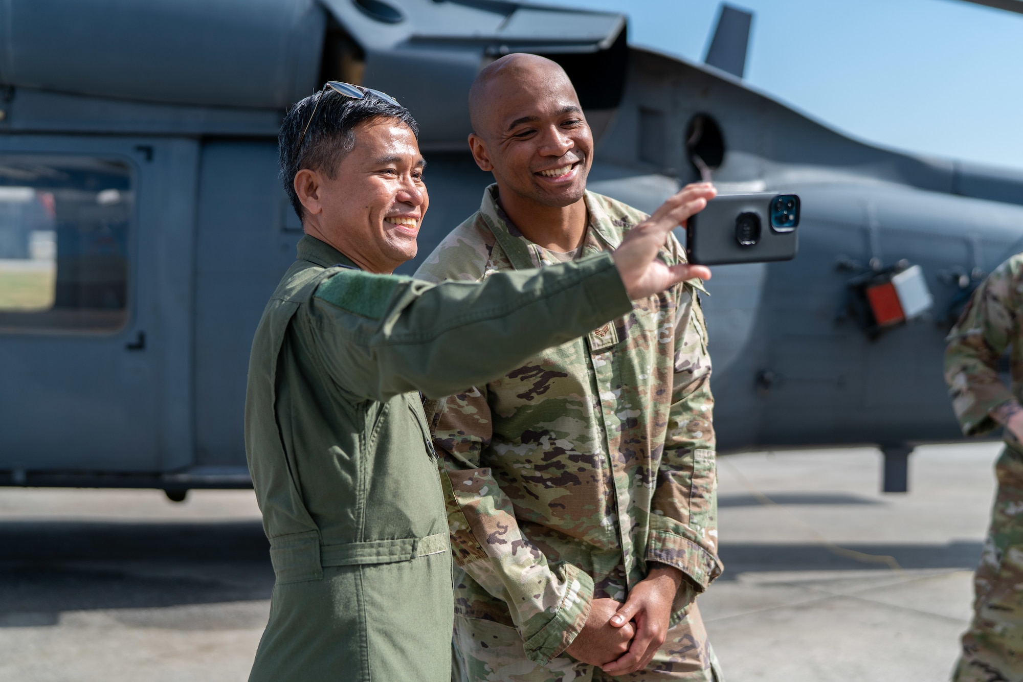 A Philippine Air Force member poses for a photo with an Airman.
