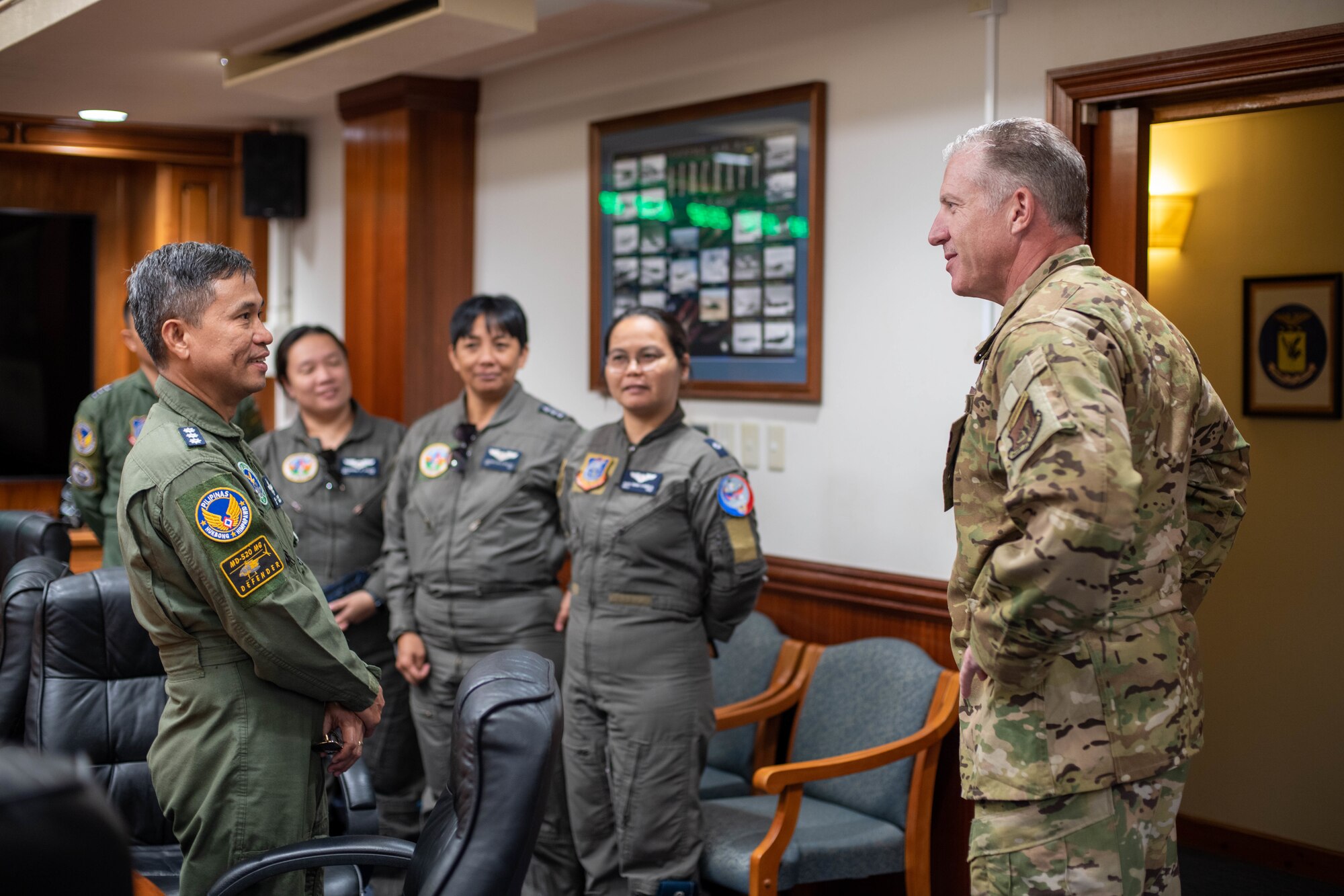 An Airman and Philippine Air Force members meet.