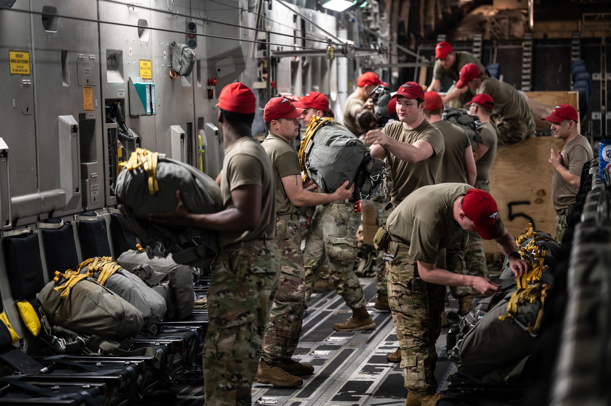 U.S. Army parachute riggers, assigned to the 82nd Airborne Division, position parachutes throughout a U.S. Air Force C-17 Globemaster III, assigned to Joint Base Charleston, South Carolina, during Exercise Cobra Gold 2023 on a flight line at Diego Garcia, British Indian Ocean Territory, Mar. 1, 2023. Cobra Gold, now in its 42nd year, is a Thai-U.S. co-sponsored training event that builds on the long-standing friendship between the two allied nations and brings together a robust multinational force to promote regional peace and security in support of a free and open Indo-Pacific. (U.S. Air Force photo by Staff Sgt. Alan Ricker)